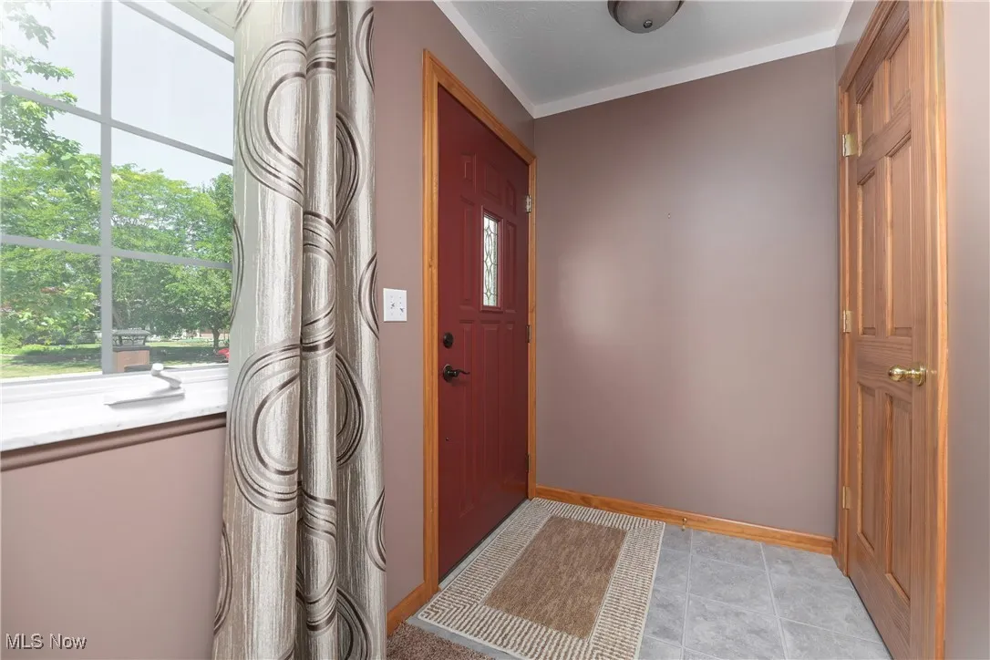 Foyer entrance with baseboards