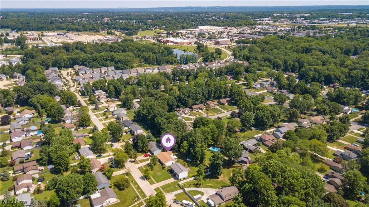 Aerial view of property's location featuring nearby suburban area