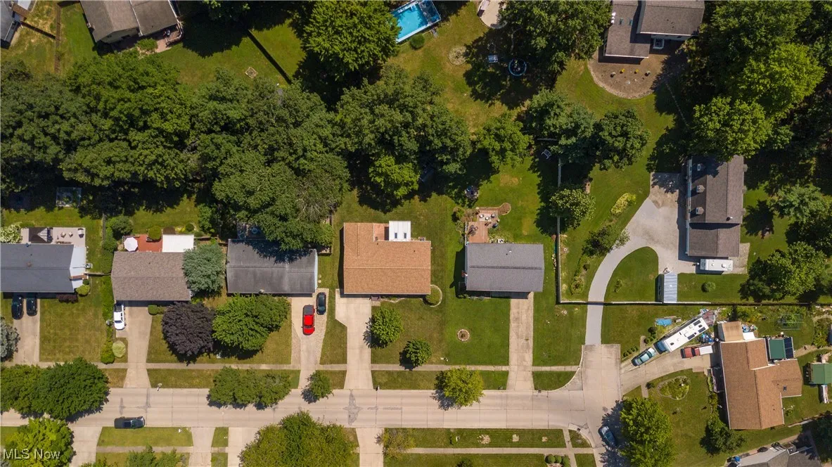 Aerial view of property and surrounding area featuring nearby suburban area