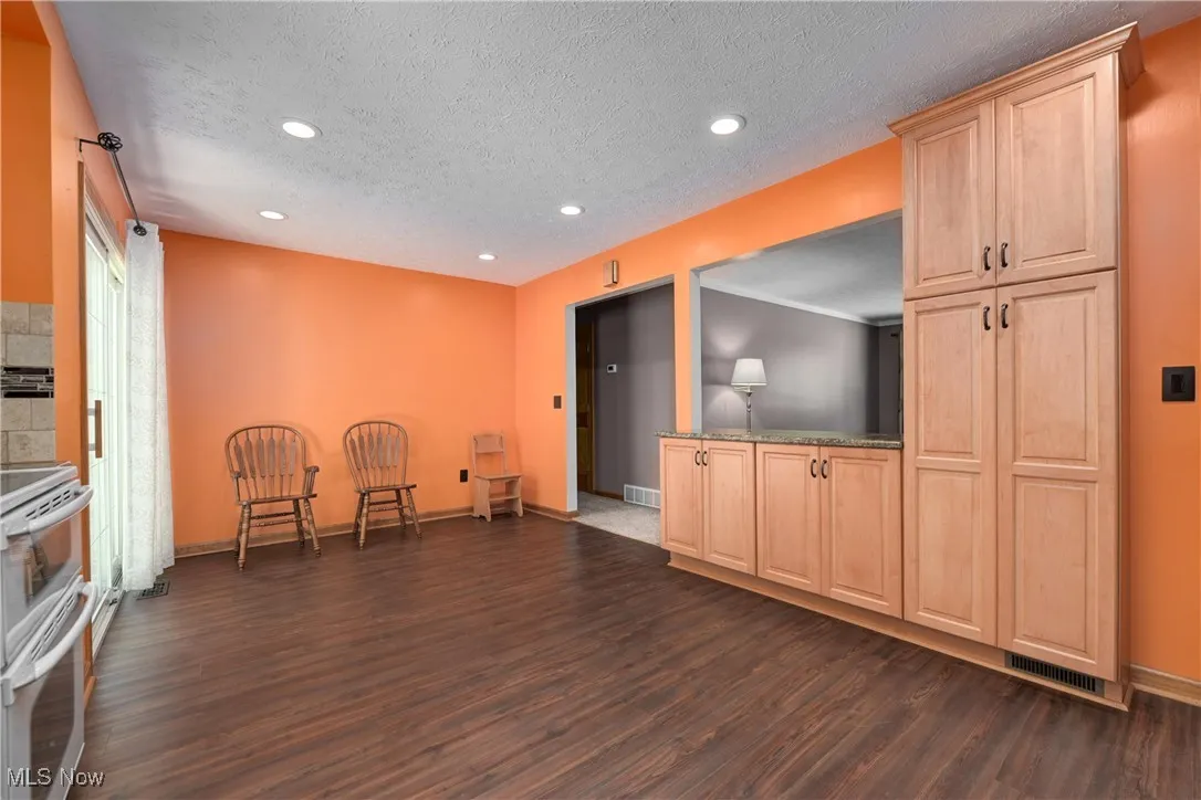 Unfurnished room with dark wood-type flooring, recessed lighting, and a textured ceiling