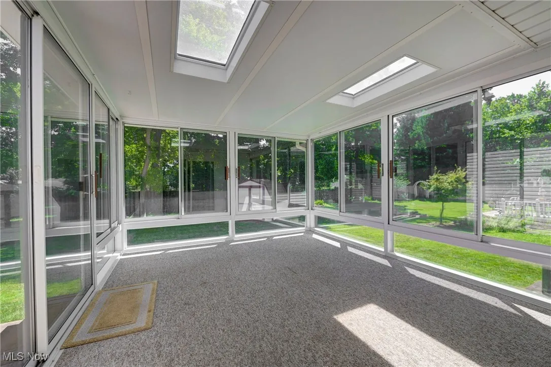 Unfurnished sunroom with a skylight