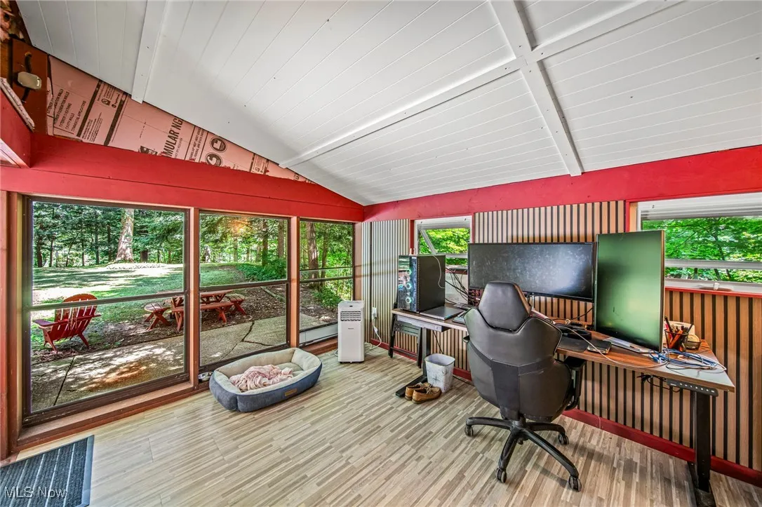 Office space featuring lofted ceiling and wood finished floors