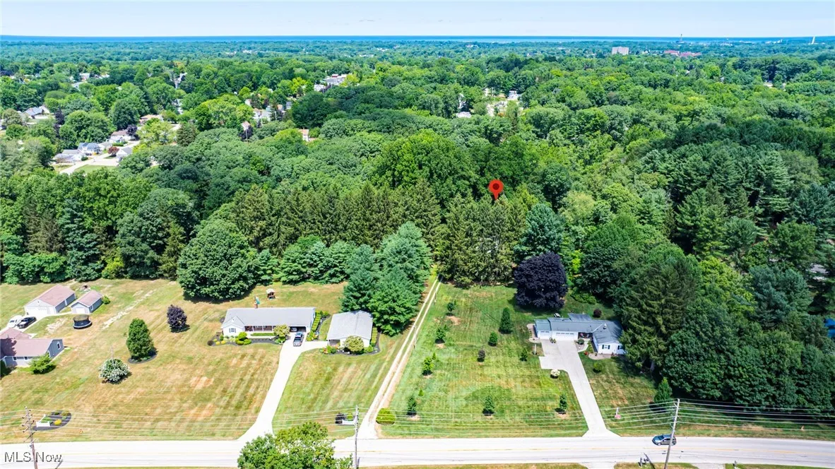 View of property location featuring a forest