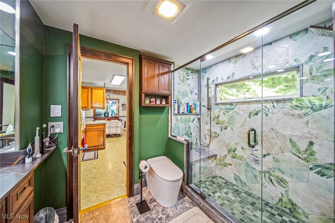 Bathroom with vanity and a stall shower