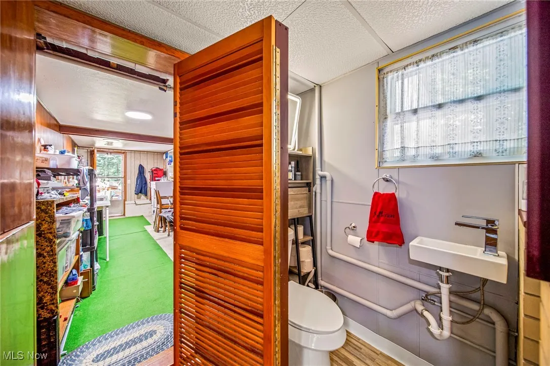 Bathroom with a textured ceiling and wood finished floors