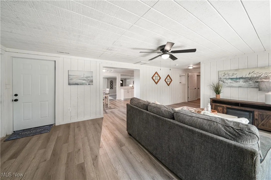 family room with newer LVP and new fan.