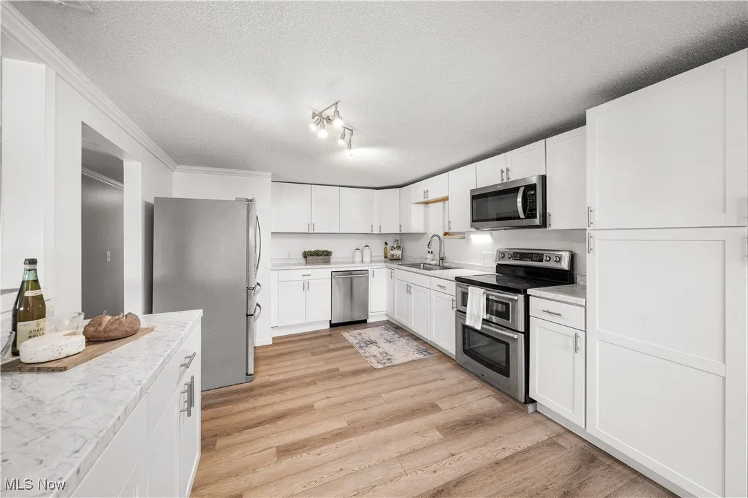 this recently updated kitchen offers custom cabinets, newer countertops and stainless steal appliances.