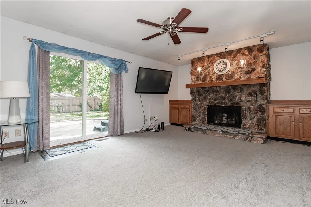 Family room with fireplace and sliding glass door onto back deck