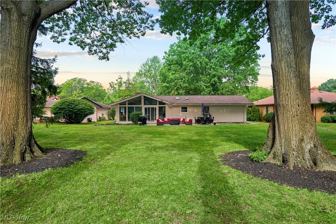 Back of property with a yard, an outdoor hangout area, and a patio area