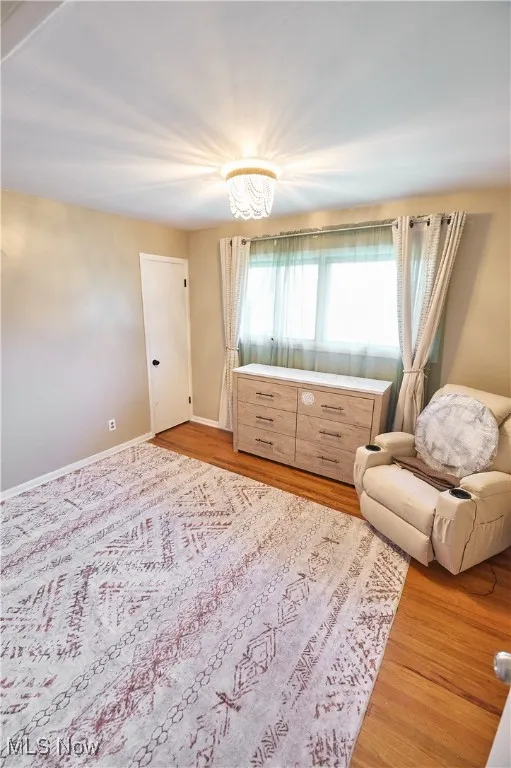 Living area featuring light wood-style flooring and baseboards