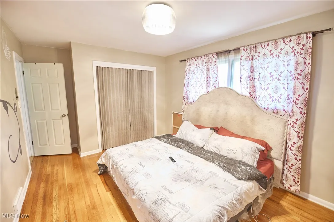 Bedroom featuring wood finished floors and a closet