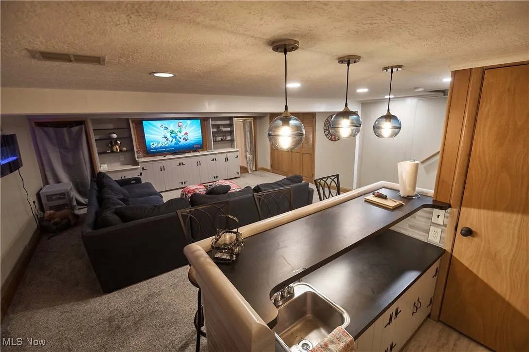 Playroom featuring a textured ceiling, recessed lighting, and light carpet