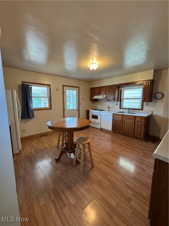 Dining area featuring plenty of natural light and wood finished floors