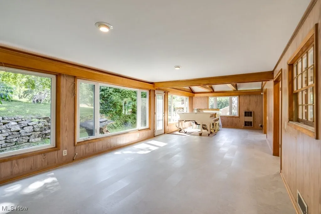 Unfurnished sunroom with heating unit