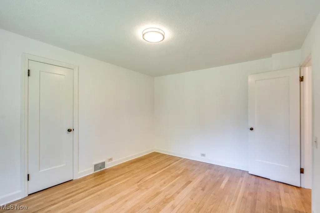 Unfurnished room with light wood-style flooring and baseboards