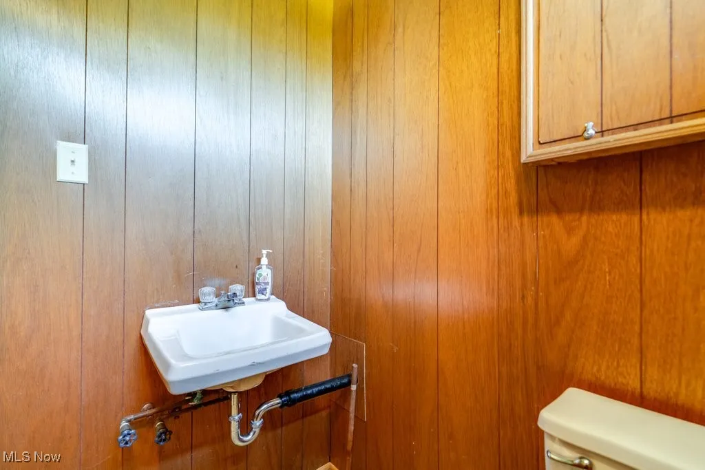 Half bath with wood walls