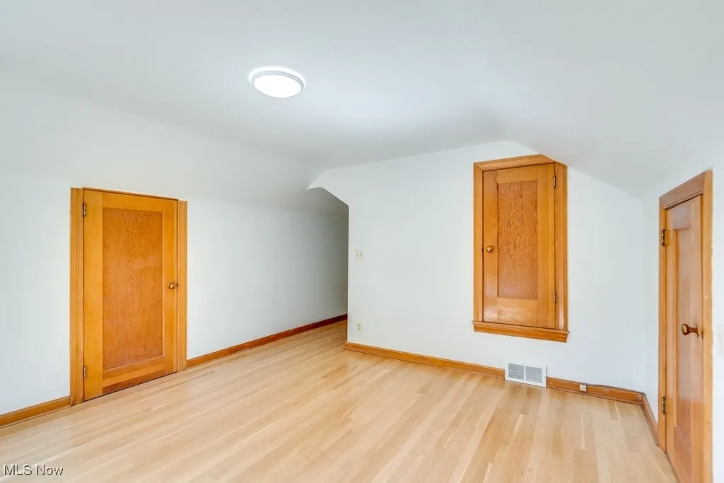 Bonus room featuring lofted ceiling and light wood-type flooring