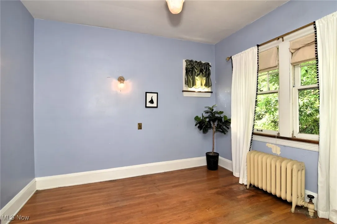 Spare room with radiator and wood finished floors