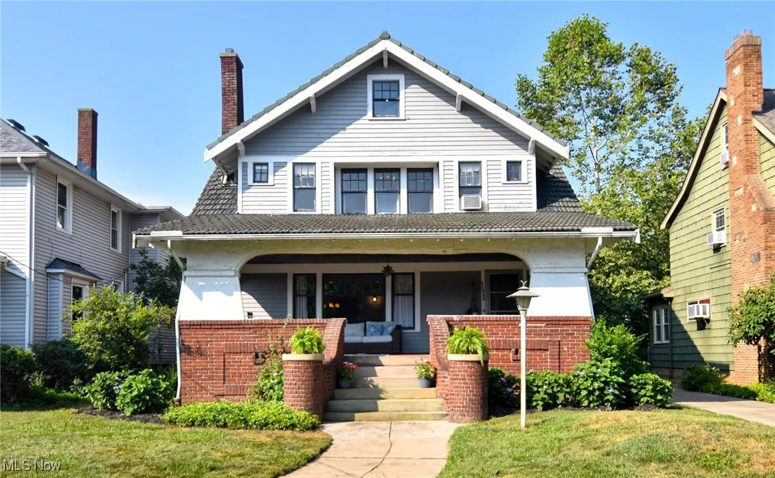 View of front of house featuring brick siding and a porch