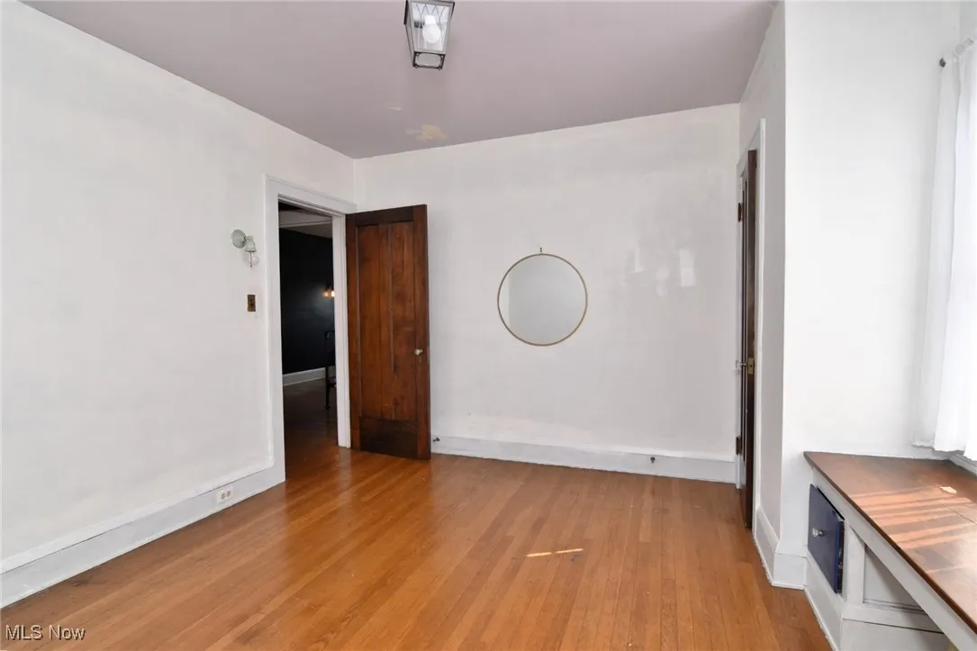 Spare room featuring light wood-type flooring and baseboards