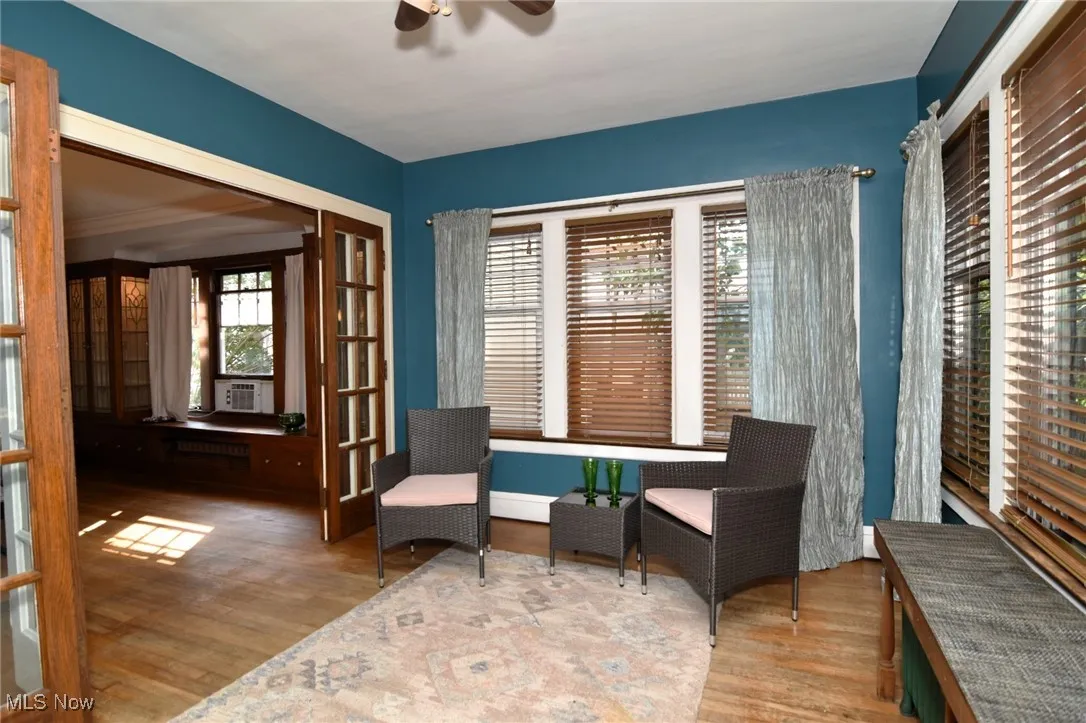 Living area with ceiling fan and wood finished floors