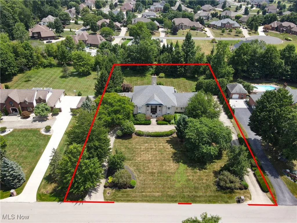 Aerial perspective of suburban area featuring property parcel outlined