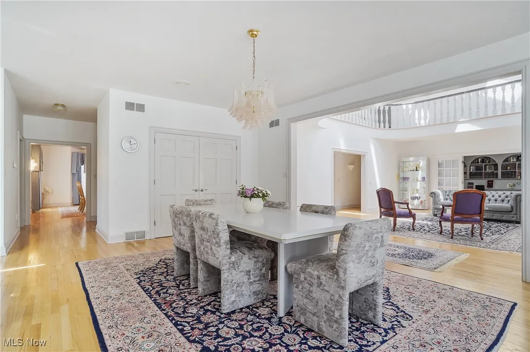 Dining space with light wood-style floors and a chandelier