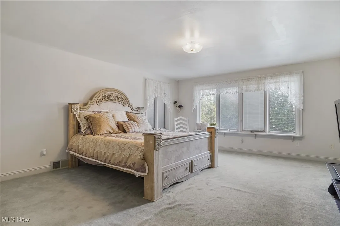 Bedroom featuring light colored carpet