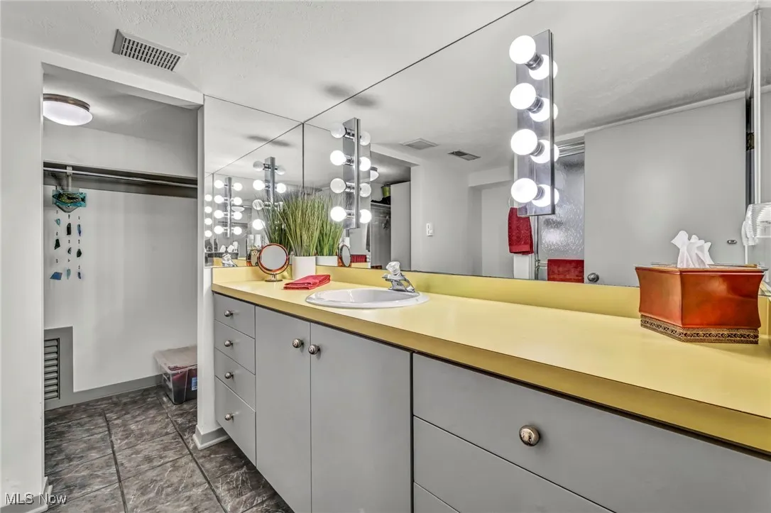 Bathroom featuring vanity and a textured ceiling
