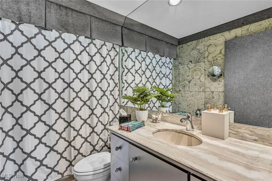 Full bath featuring vanity and a shower with curtain