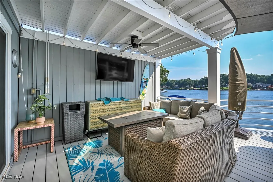 Deck featuring an outdoor living space and a ceiling fan