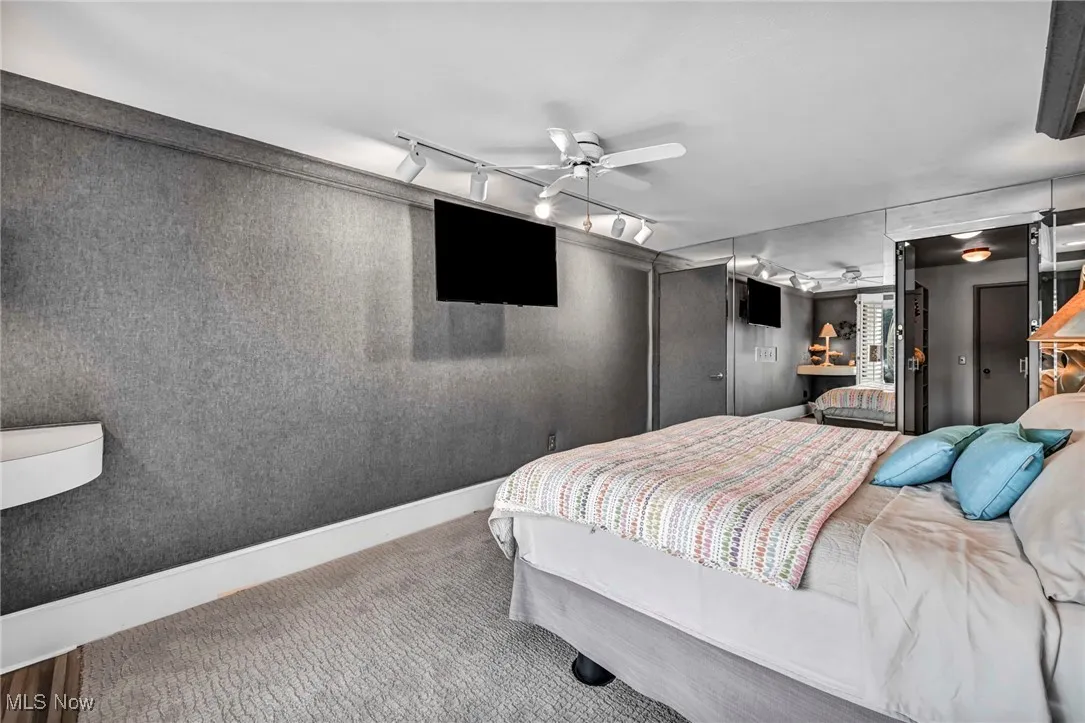 Bedroom featuring rail lighting and carpet floors