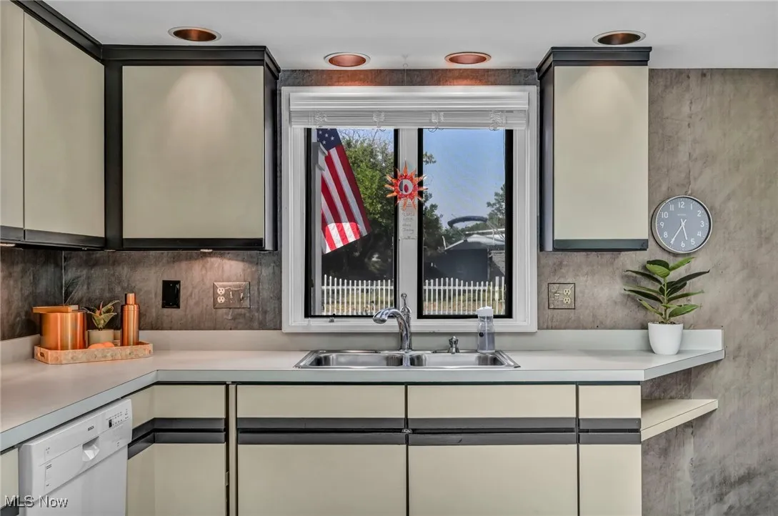 Kitchen with light countertops and white dishwasher