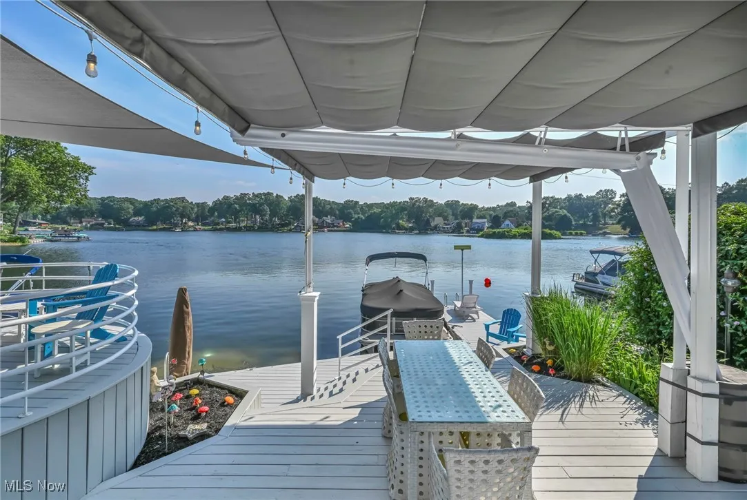 Dock area with a water view and boat lift