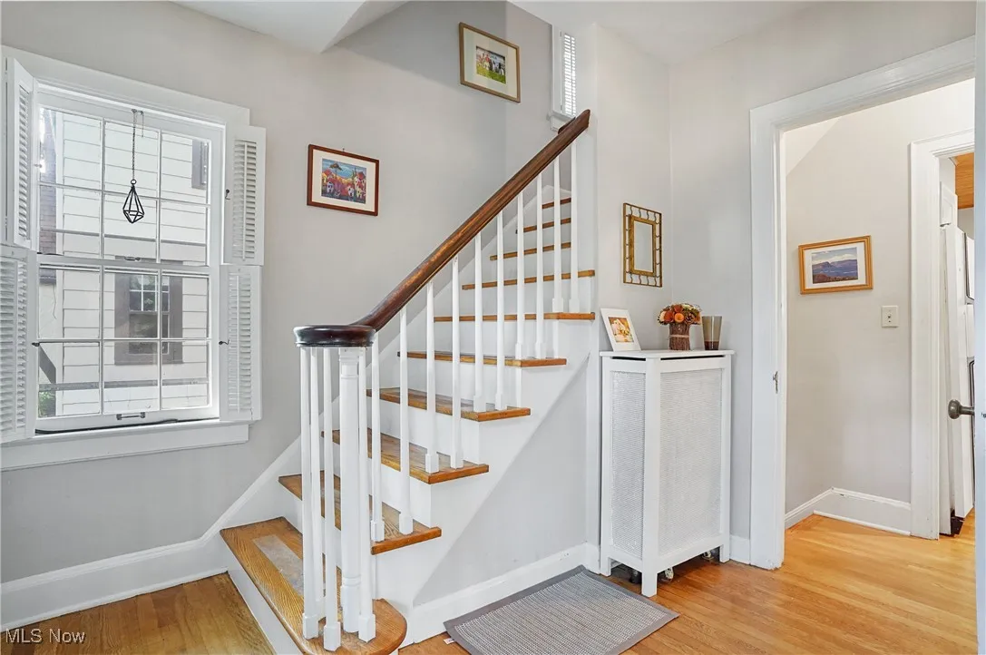 Staircase featuring baseboards and wood finished floors