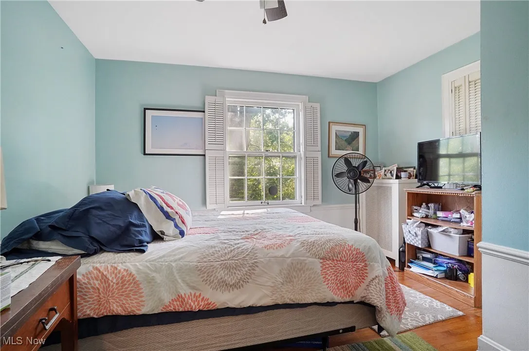 Bedroom featuring wood finished floors and ceiling fan