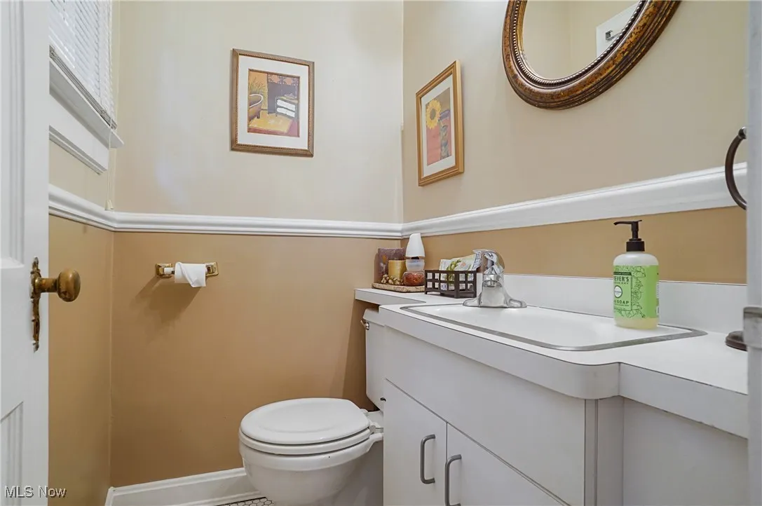 Half bath featuring toilet and vanity
