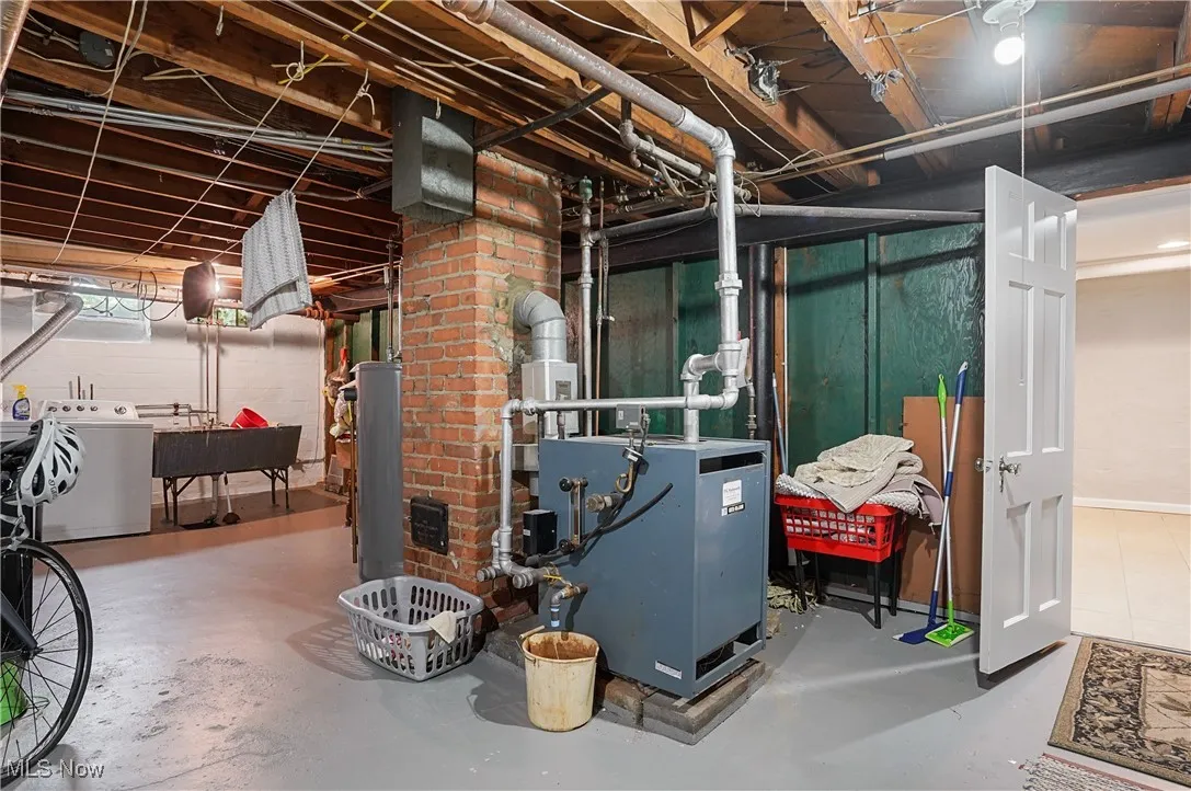 Unfinished basement with a heating unit and water heater