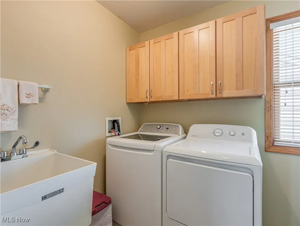 Laundry conveniently located on the second level next to the bedrooms and has a utility tub and additional storage space