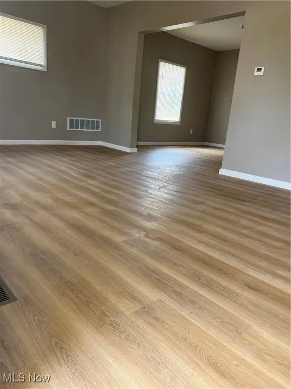 Unfurnished room with baseboards and wood finished floors