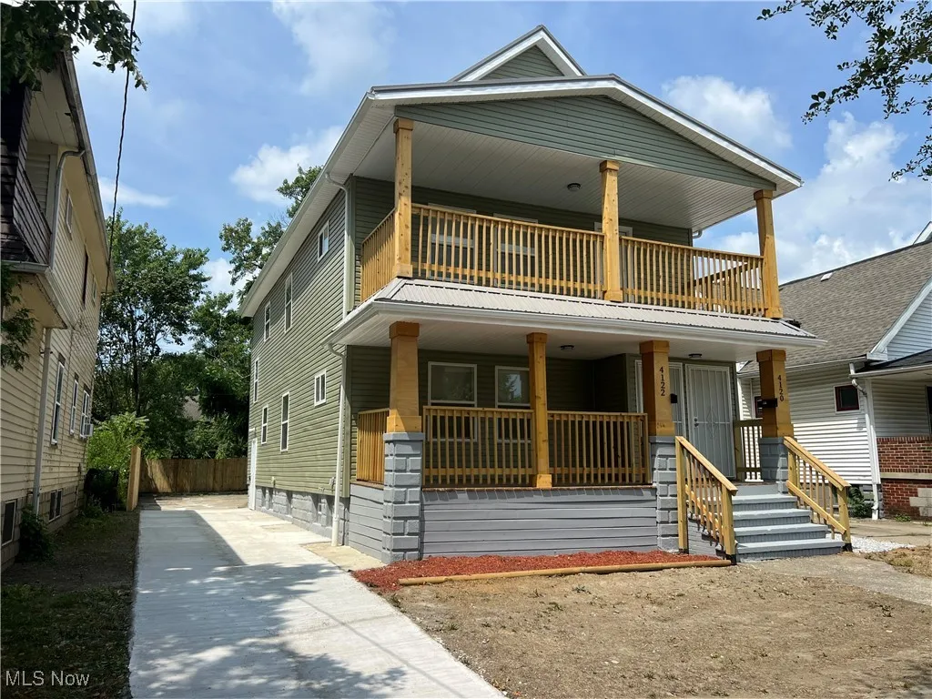 View of front of property featuring a balcony and a porch