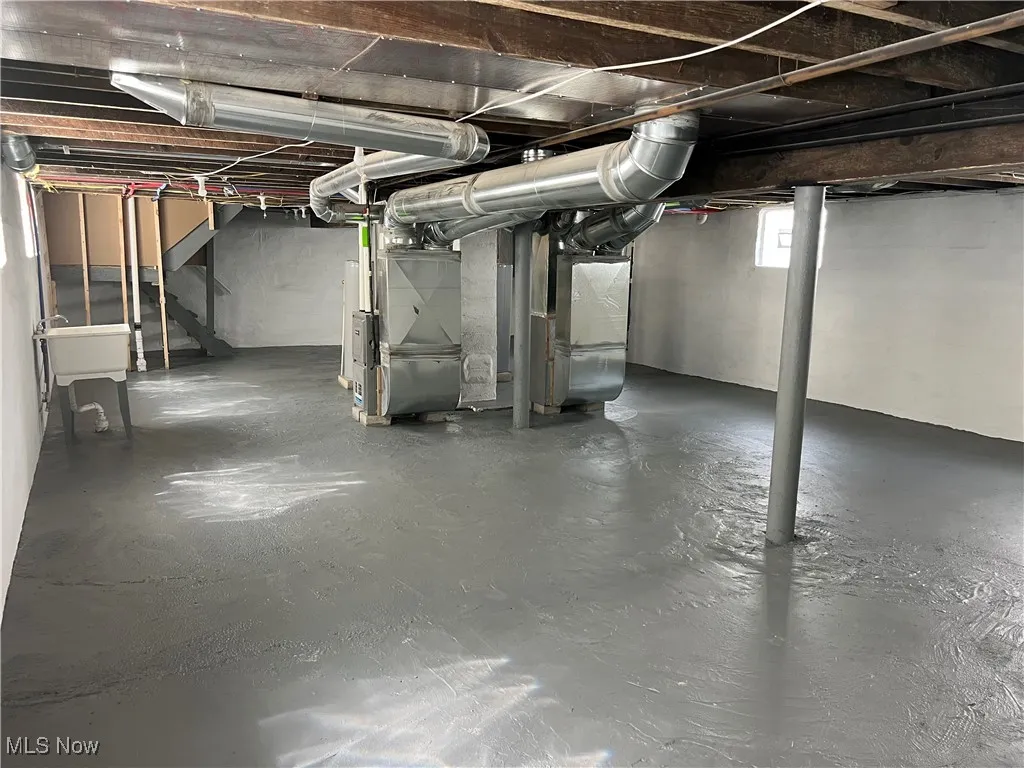 Basement with stairway and heating unit