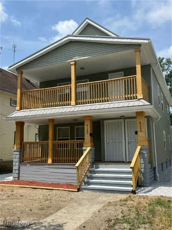 View of front of house with a balcony and a porch