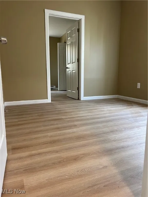 Unfurnished room featuring wood finished floors
