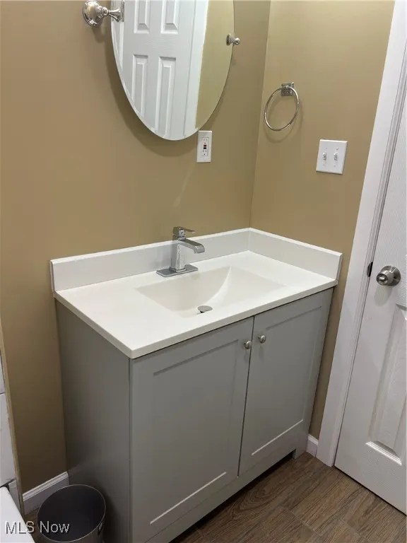 Bathroom featuring vanity and wood finished floors