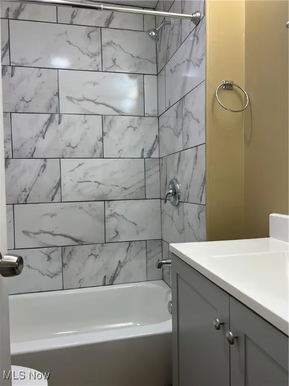 Bathroom featuring vanity and tub / shower combination