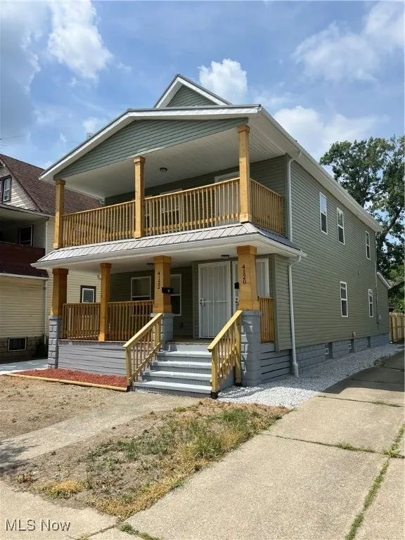 View of front of house with a balcony and a porch