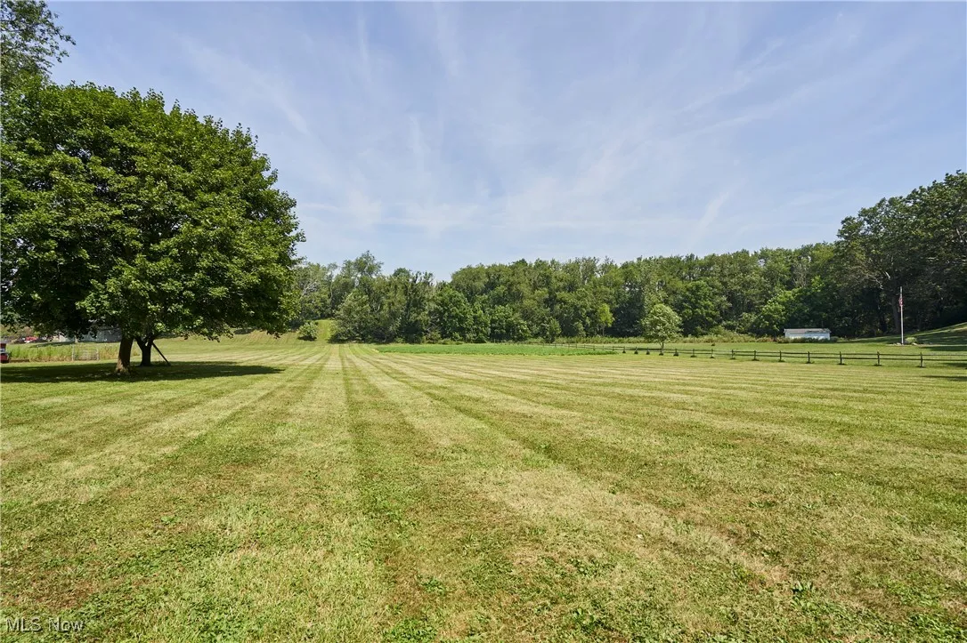 View of yard featuring a view of countryside and a forest view