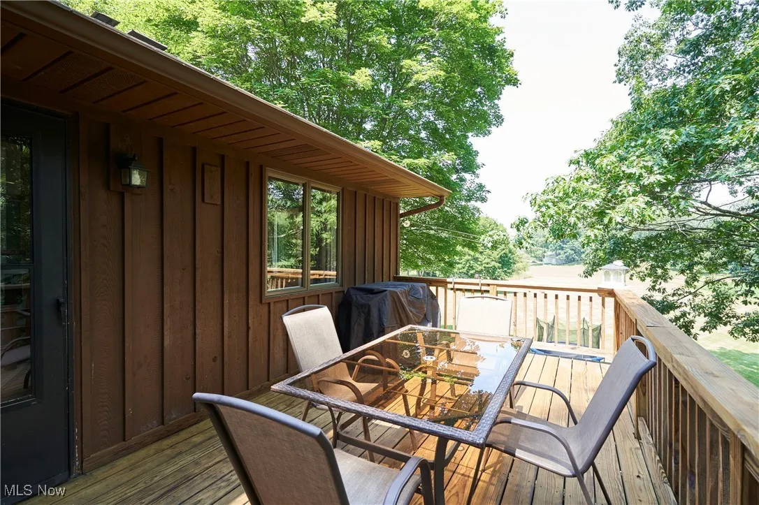 Deck featuring outdoor dining space ,tree house ,back yard views