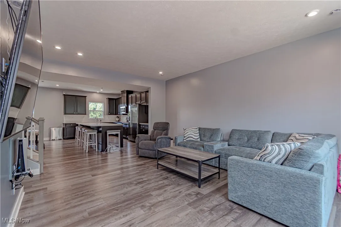 Living room with recessed lighting and wood finished floors
